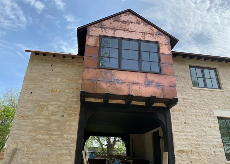 Copper metal panel facade on a stone building for Metal Roof Coating in Eureka