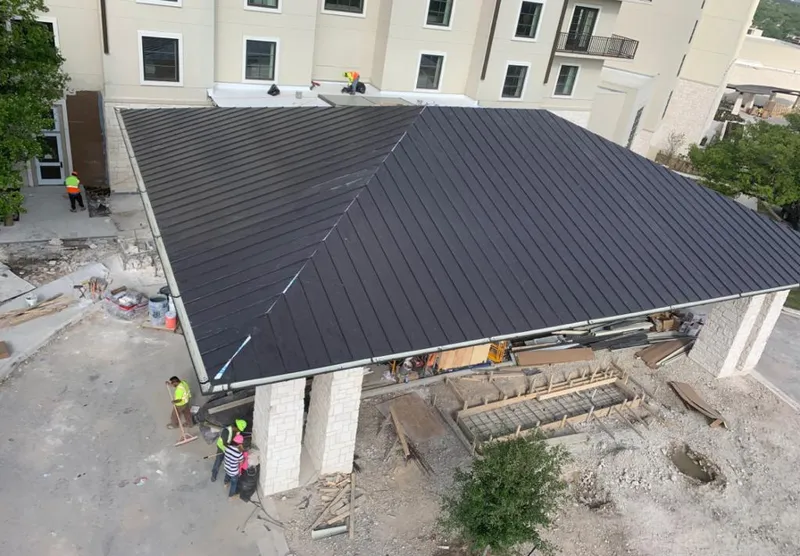 Metal roofing installation team working on a commercial building in Eureka